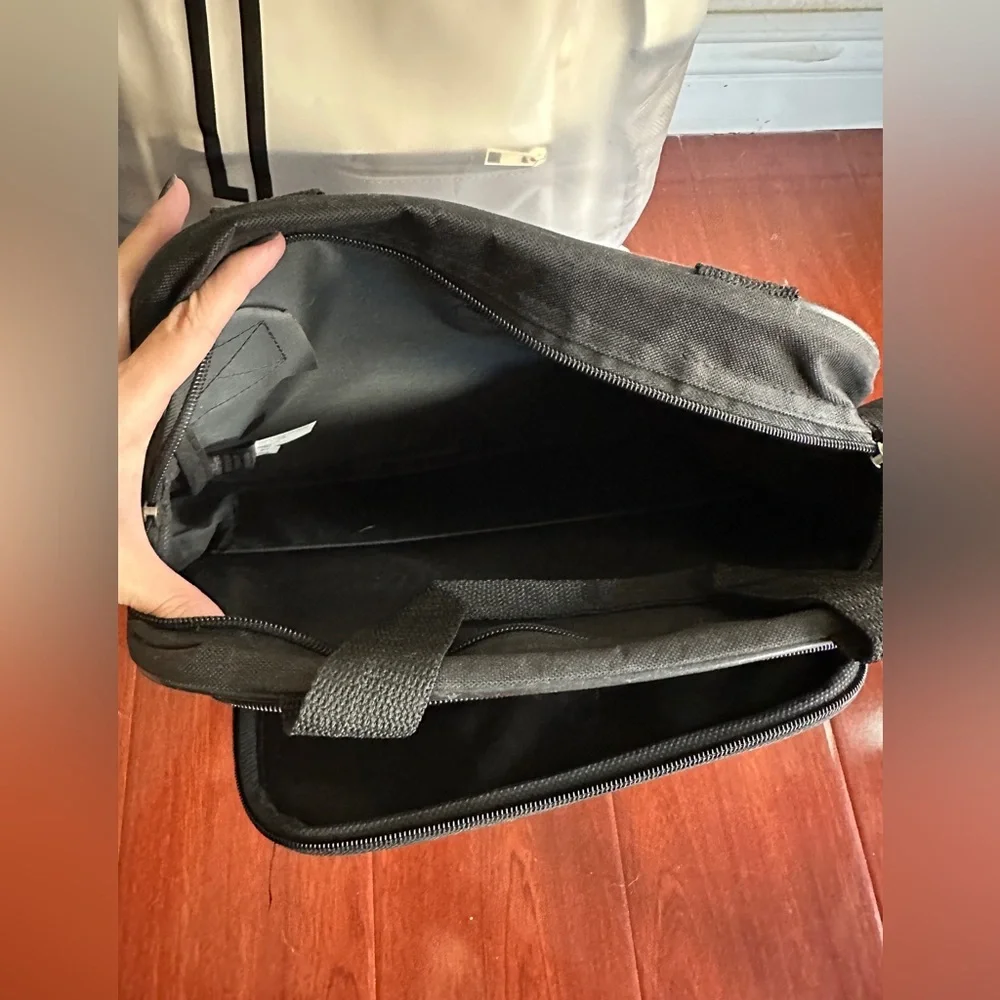Men’s minimalist black carrying bag for travel or everyday use. Airplane logo.
